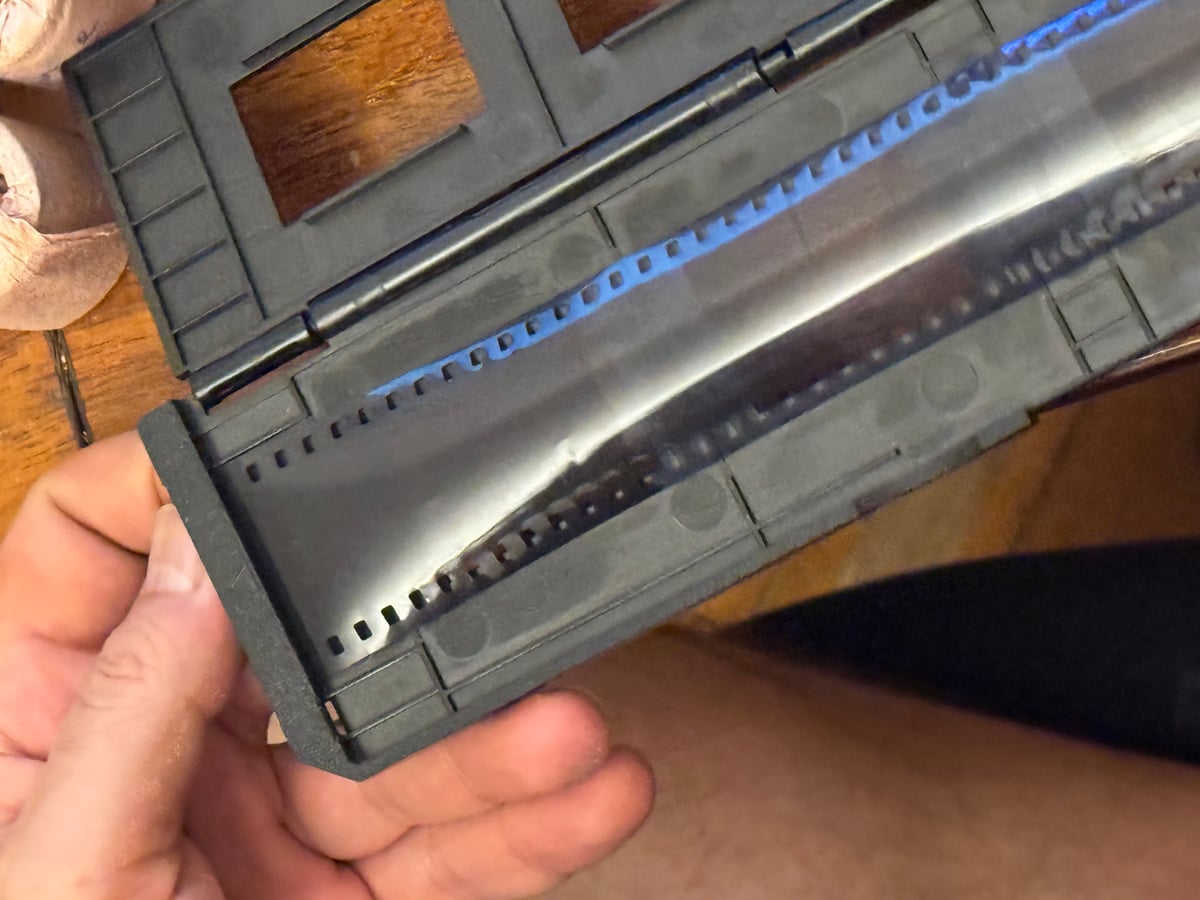 Close-up view of the 35mm film scanning process